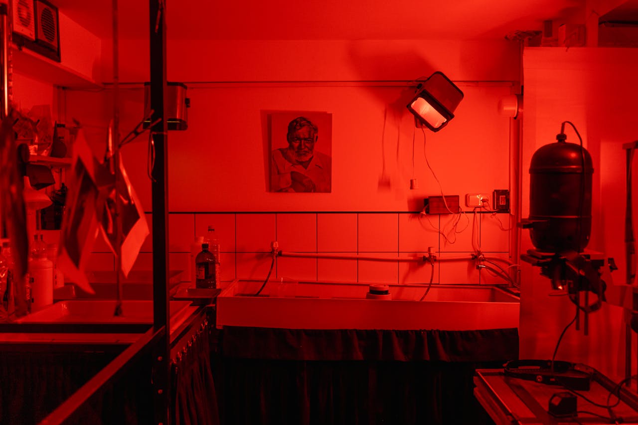 creative A nostalgic look at a red-lit film photography darkroom, evoking vintage charm and analog processes.